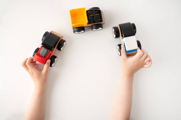 child playing with toy vehicle
