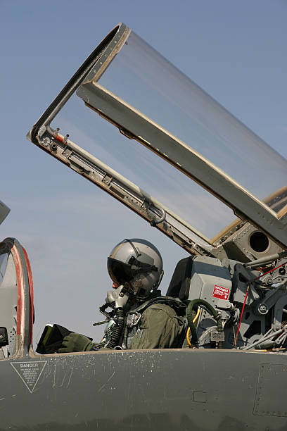 Fighter pilot getting ready to fly A fighter pilot sits in his jet doing a last minute check before taking off. oxygen mask plane stock pictures, royalty-free photos & images