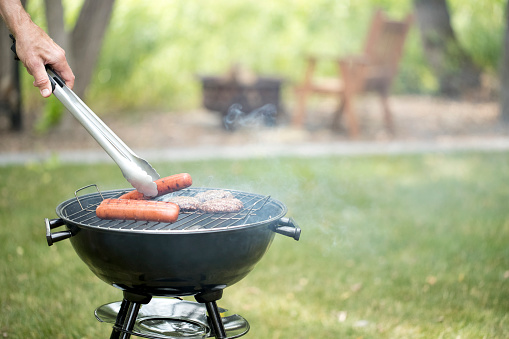 barbecue grill with smoke on summer backyard party