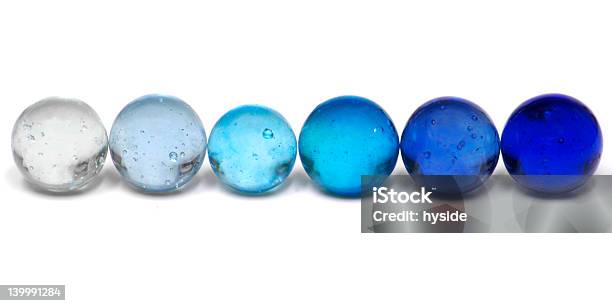 Blue Marbles In A Graduated Row Stock Photo - Download Image Now - Marbles, Sphere, Remote Location