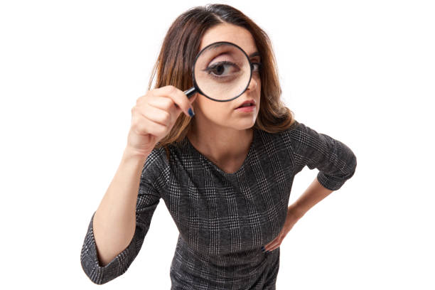 Businesswoman looking through magnifier stock photo