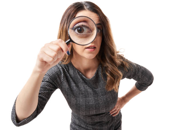 istock Businesswoman looking through magnifier 1399913255