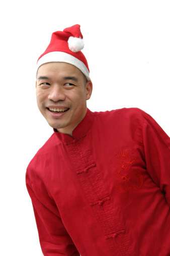 Chinese man in a red Chinese top and Santa hat