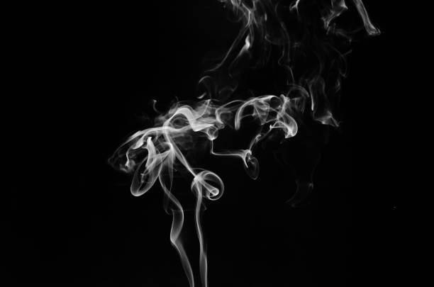 istock abstract fragment movement of white smoke on black background. 1399914829