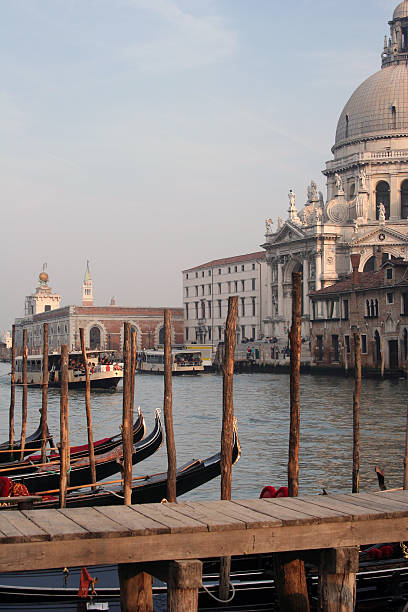 Grand Canal at Dusk The gorgeous late-day sun bathes the church at the mouth of the Grand Canal in Venice, Italy. venice italy grand canal honeymoon gondola stock pictures, royalty-free photos & images