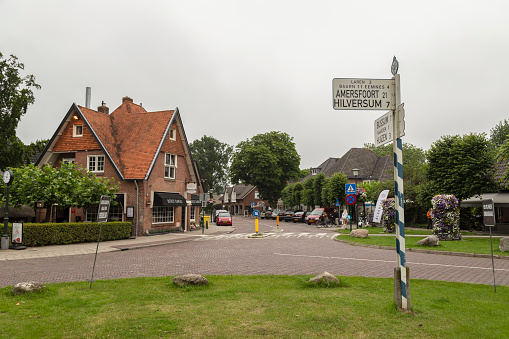 Blaricum, The Netherlands, July 14, 2021; Traffic intersection with signage in the center of the town of Blaricum.