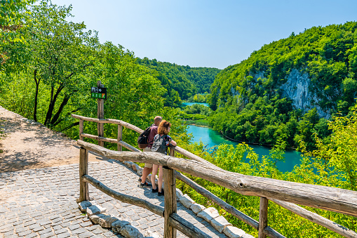 Plitvice, Croatia - 21.7.2021: Tourists are visiting the beautiful nature park, Plitvice lakes and waterfalls. Famous travel destination, fresh water in pure nature.