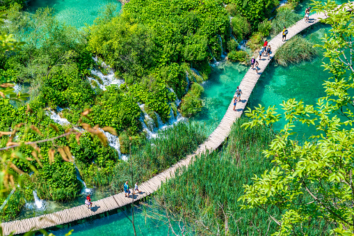 Plitvice, Croatia - 21.7.2021: Tourists are visiting the beautiful nature park, Plitvice lakes and waterfalls. Famous travel destination, fresh water in pure nature.