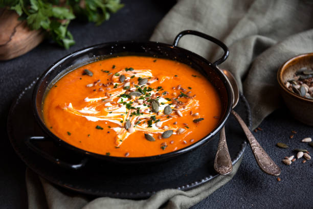 istock Pumpkin soup with cream and parsley in bowl 1399920149