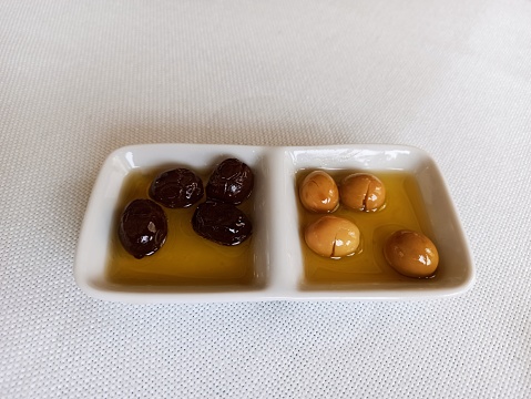 Green and black olive with olive oil serving at Istanbul turkey