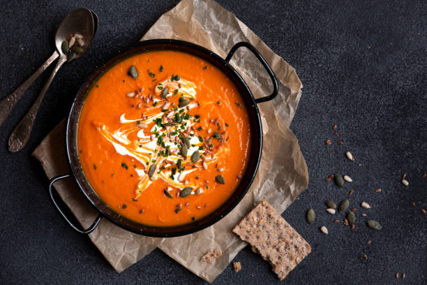 istock Pumpkin soup with cream and parsley in bowl 1399920162