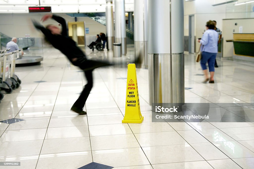 Slipped Man slips next to Wet Floor sign Falling Stock Photo