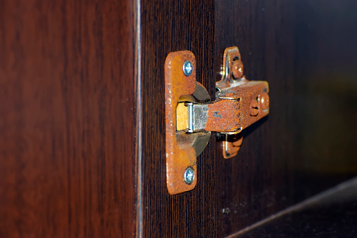 rusty furniture hinge close-up. selective focus