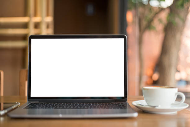 istock Mockup of laptop computer with empty screen with coffee cup and smartphone on table of the coffee shop background,White screen 1399926734