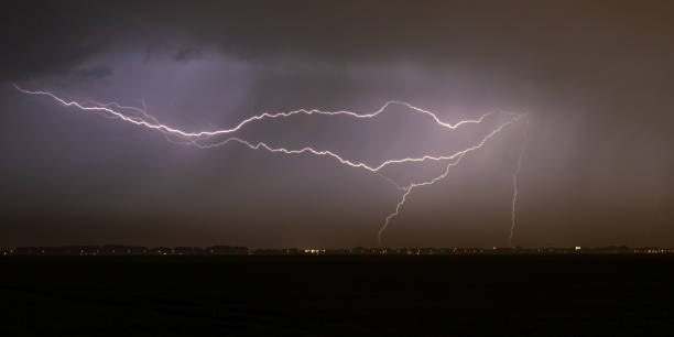 istock Nighttime image of several lightning bolts cutting through the sky 1399929041