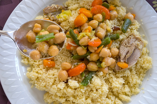 Moroccan couscous dish with vegetables, chicken and chickpeas