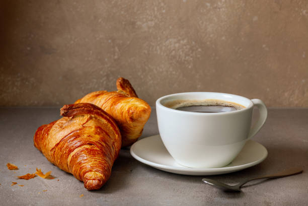 istock cup of coffee and croissants 1399929816