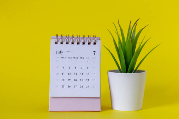 istock Desktop calendar for July 2022 on a yellow background. 1399930413