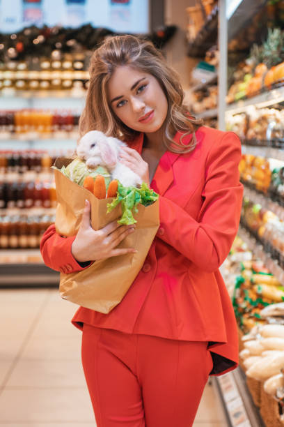 istock Young woman in a supermarket with her rabbit 1399931734