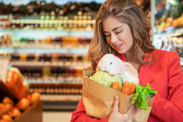 istock Young woman in a supermarket with her rabbit 1399931736