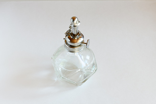 Perfume is held by a persons hand in a store isle