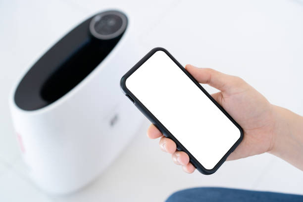 istock Woman using application to control an air purifier. 1399933320