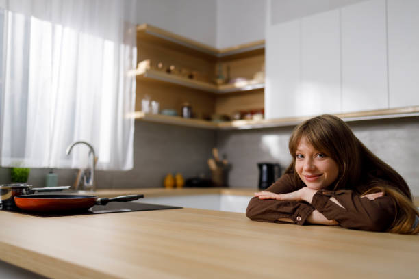 istock Joyful dreaming girl in the kitchen 1399934468