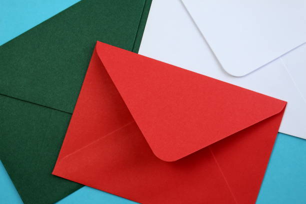 istock Three envelopes of different colors lie on a blue background. 1399934823