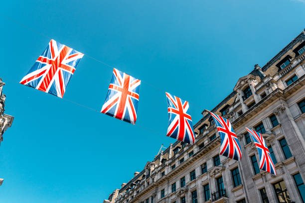 london architecture: union jack flags - urban scene regent street city of westminster inner london imagens e fotografias de stock