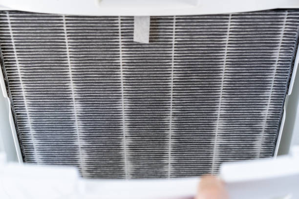 istock Woman changing air purifier filter. 1399934995