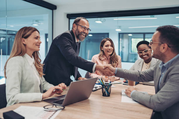 istock Businessmen shaking hands across the table 1399935961