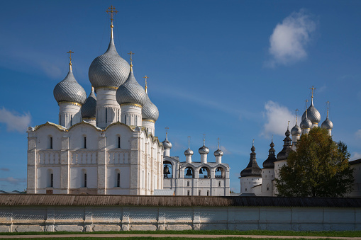 View of the domes of the Assumption Cathedral, the Church of the Resurrection and the belfry over the wall of the Rostov Kremlin on a sunny day, Rostov Veliky, Yaroslavl region, Russia