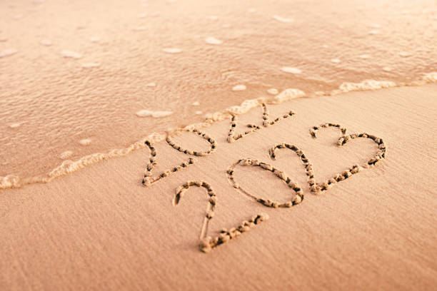 New Year 2023 replace 2022 on the sea beach summer. New Year 2023 replace 2022 on the sea beach summer. New Year 2023 is coming concept. 2023 photos stock pictures, royalty-free photos & images