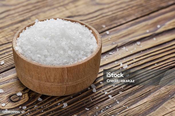Salt In A Hodgepodge On A Wooden Table Stock Photo - Download Image Now - Baked, Baked Pastry Item, Bakery