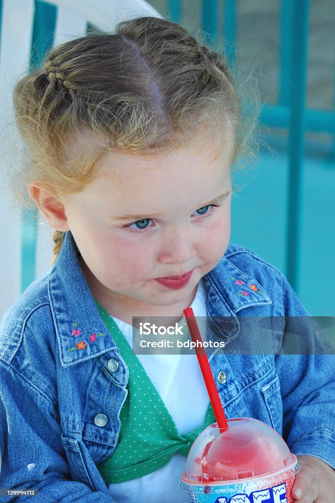 Girl Enjoying a Cool Treat Young cute gitl enjyoing a cool frozen treat Eating Stock Photo