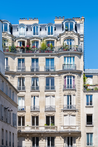 Paris, typical facade boulevard Magenta, beautiful building, with old zinc roofs
