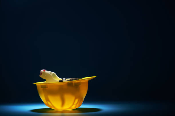 yellow helmet upside down against blue background