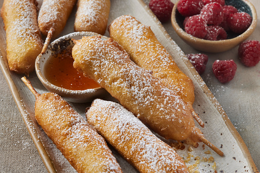 Pancake Breakfast Sausages on a Stick with Powdered Sugar and a Maple Syrup Dip