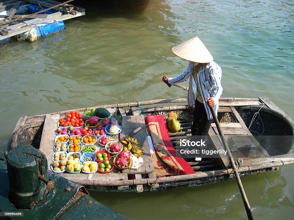 Vietnam floating market A small boat selling fresh fruits in Halong Bay, Vietnam. Vietnam Stock Photo