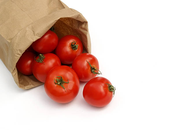 tomatoes in a paper bag stock photo