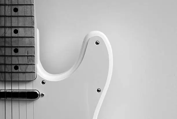 white guitar closeup against white background