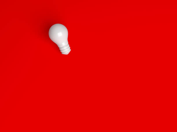 istock White color light bulb icon on red color background. 1399945817