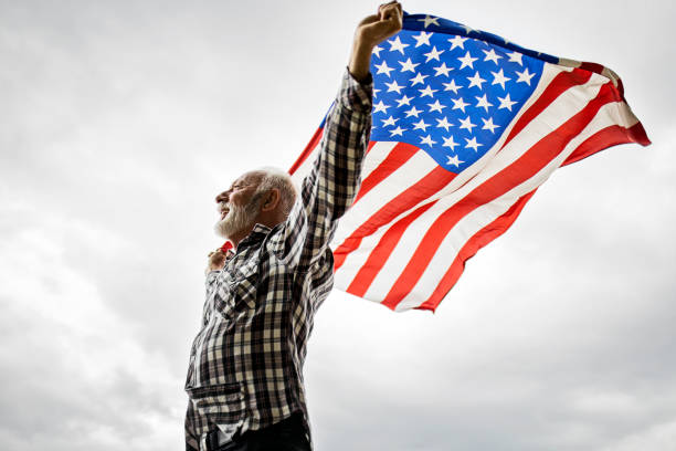 istock Holding the USA Flag 1399946888