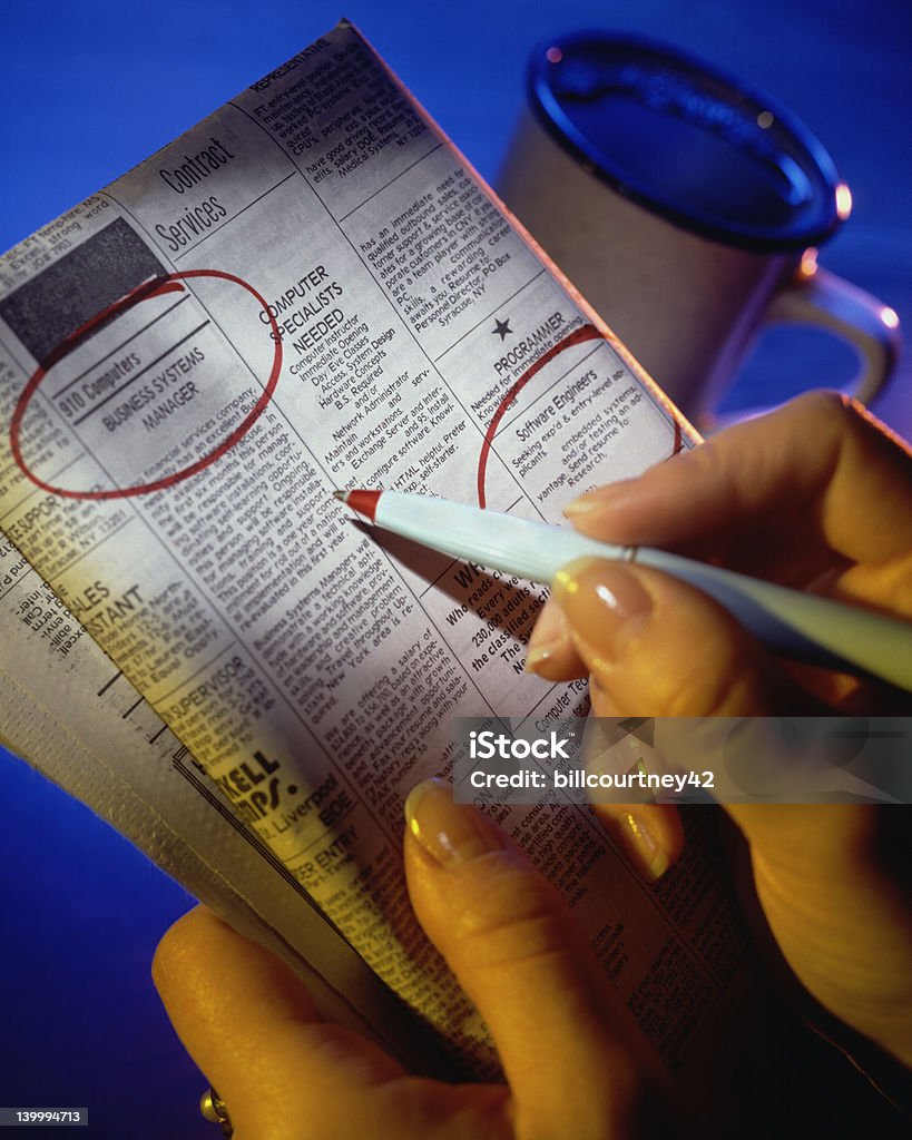 Want Ads on Blue Hands marking jobs selections in news paper want ads Advertisement Stock Photo