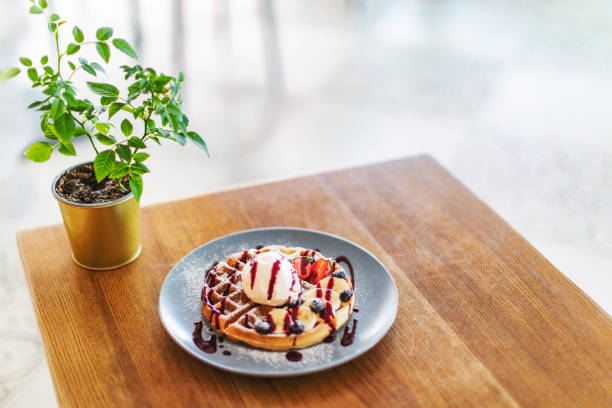 Belgian waffle with ice cream, chocolate and berries
