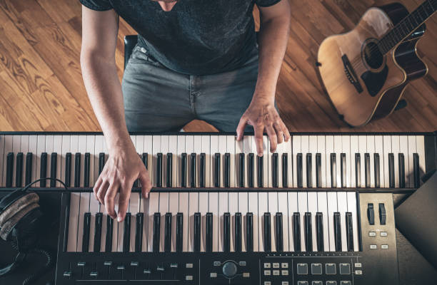 istock Male hands on the piano keys, top view. 1399947951