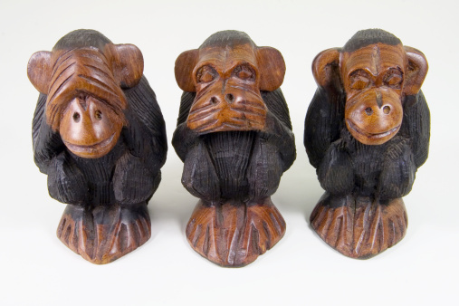 Three African statuettes of wise monkeys that see no evil, speak no evil and hear no evil.