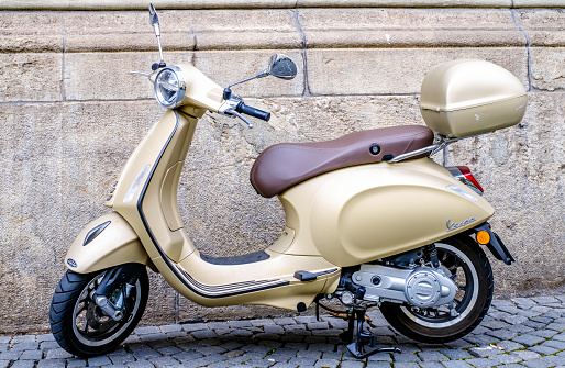 Siena, Italy - April 6:typical italian Vespa Motorscooter (build from Piaggio) at a street in Siena on April 6, 2022