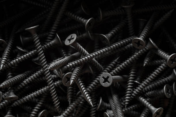 Close up Black Drywall Screws in a box