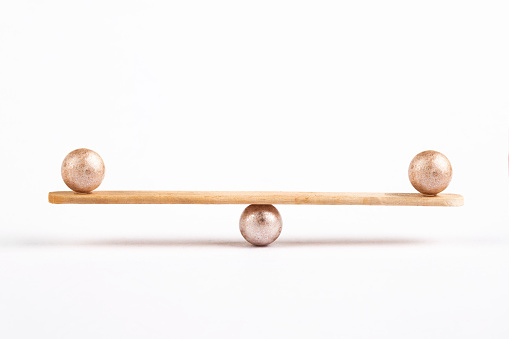 Seesaw with balls on white background